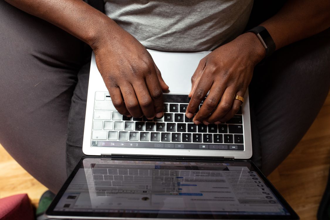 Person typing on a laptop, representing AI-assisted content creation for founders